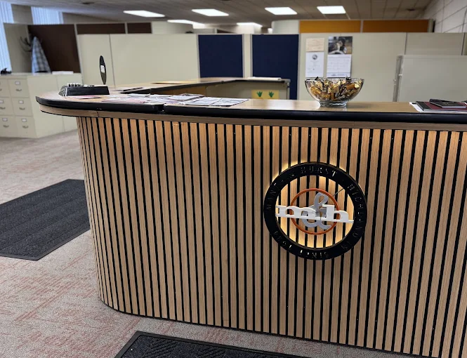 Reception desk with the Manta & Hurst logo inside the Highland office