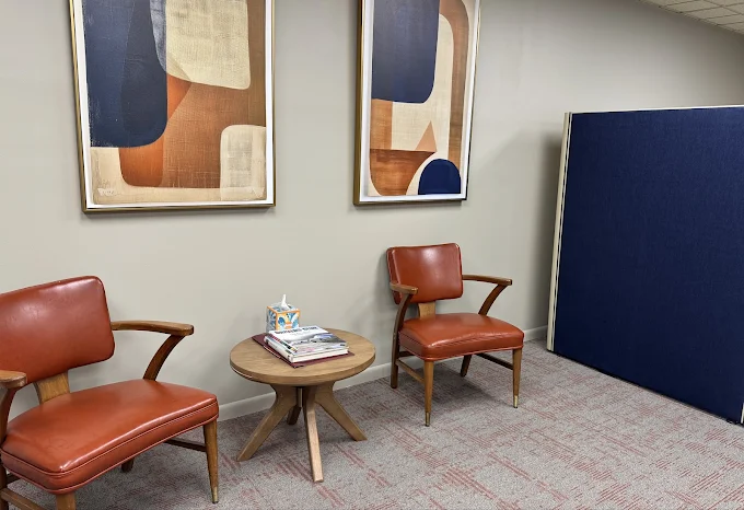Waiting area with chairs and a side table inside the Highland office
